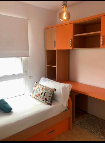 a bedroom with a desk and a bed with a pillow at Light House in Corralejo