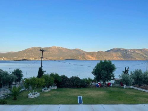 a view of a large body of water with mountains at Villa Marina a breath away from the sea in Áyios Dhimítrios