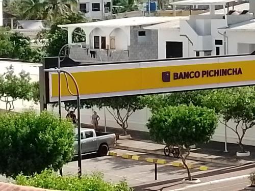 a yellow and white train on a bridge over a street at Patty House Galapagos in Puerto Ayora