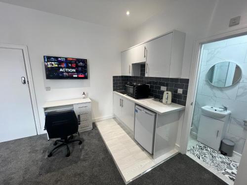 a kitchen with a desk and a chair in a room at Regent Luxury Studio in Coventry