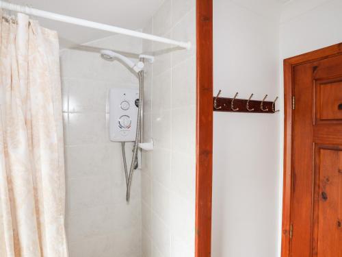 a shower in a bathroom with a shower curtain at Pen Y Garth in Pwllheli