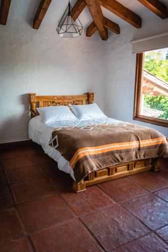 a bedroom with a bed in a room with a window at Finca La Hacienda in El Retiro