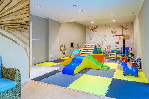 a childrens play room with a slide and a play set at KASHUBIAN Resort in Władysławowo