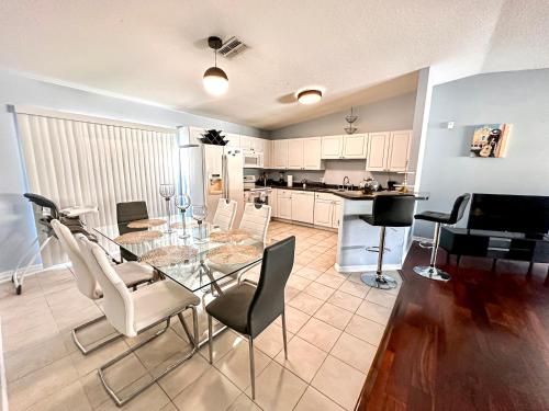a dining room and kitchen with a glass table and chairs at Familiar vacation house come to know Tampa Florida in Tampa