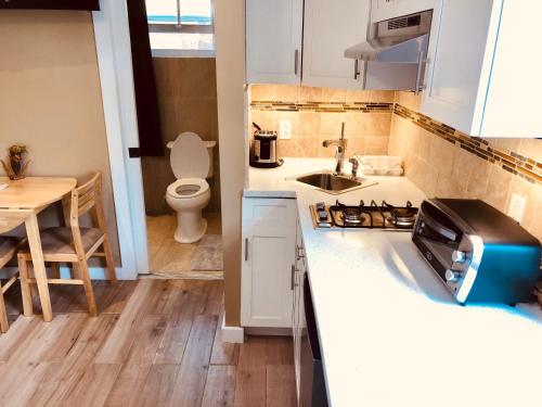 a small kitchen with a sink and a toilet at Island Retreat Studio #5 in Nassau