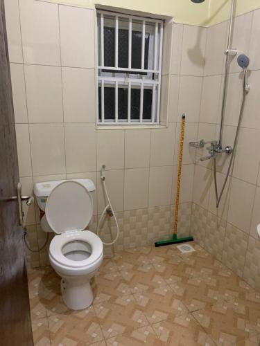 a bathroom with a toilet and a shower at Larry's Place - Gulu , Uganda in Gulu