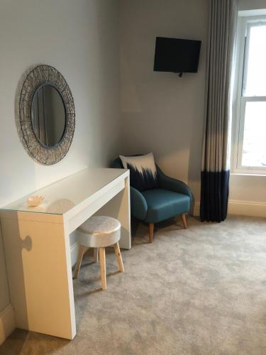 a room with a desk and a chair and a mirror at 4 Quay View, Looe in Looe