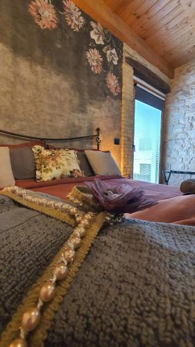 a bedroom with two beds and a wall with flowers at B&B Il Fabbro Chambre in Castelmauro