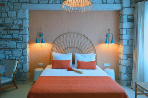 a bedroom with a large bed with red and white pillows at Rijeka Alaçatı in Cesme