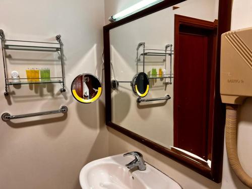 a bathroom with a mirror and a sink at Twilight Hotel Petra in Wadi Musa