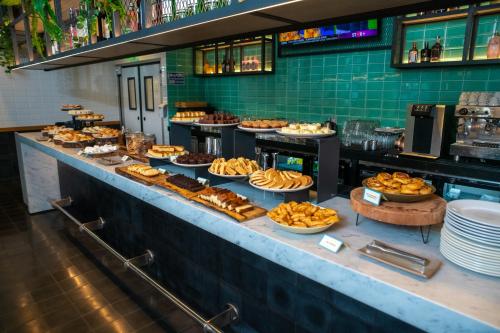 a buffet line with many different types of food at ibis styles Lima San Isidro in Lima