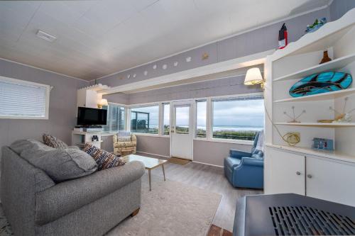 a living room with a couch and a chair at Beachside Bungalow in Rockaway Beach