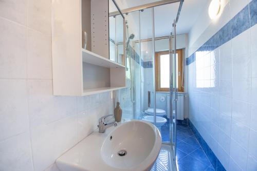 a bathroom with a white sink and two toilets at AbruzzodAmare Amazing Apartments with Romantic Sea View in Francavilla al Mare