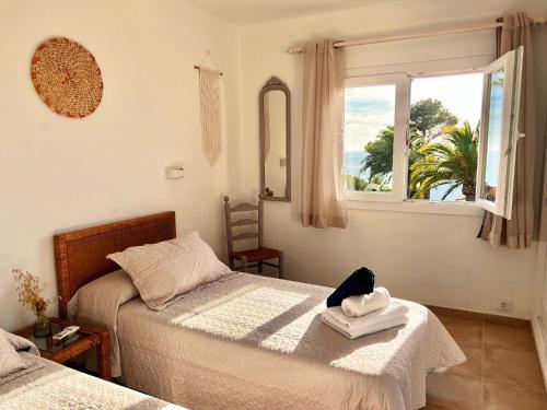 a bedroom with two beds and a window at Villa Joanna in Son Bou