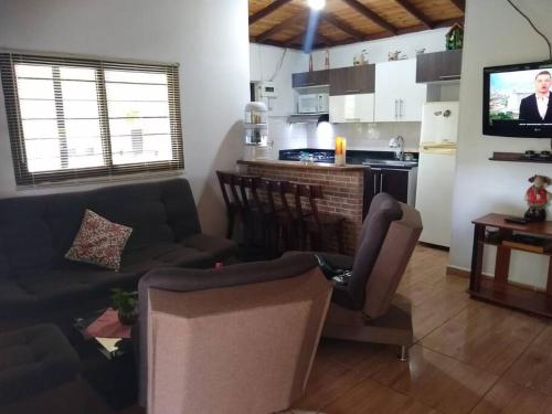 a living room with a couch and a kitchen at Cabaña la palma in Copacabana