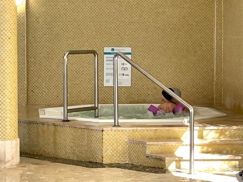 a baby in a pool of water in a bath tub at Golden Club- Eyes on Sea in Cabanas de Tavira