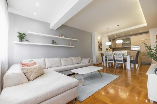 a living room with a couch and a table at Apartment Marina in Novi Sad