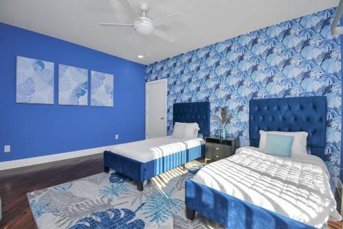a blue bedroom with two beds and a blue wall at 3BR/3.5BA Three Story East Downtown TownHouse with view in Houston