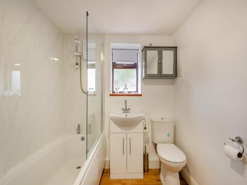 a bathroom with a toilet and a sink and a shower at Charming 1 Bedroom Cottage in Doncaster