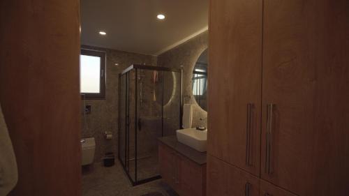 a bathroom with a shower and a sink and a toilet at Müstakil Havuzlu Villa in Şile