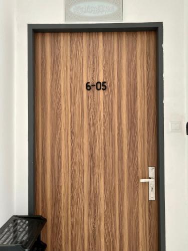 a wooden door with the number on it at Imperio Professional Suite by Mama Sue in Alor Setar