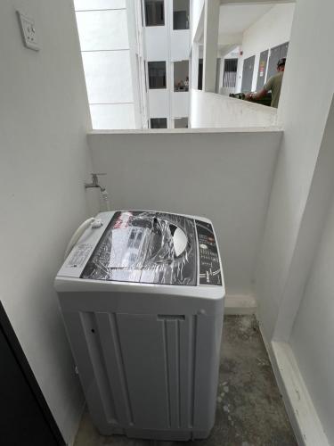 a trash can in a corner of a room with a mirror at Imperio Professional Suite by Mama Sue in Alor Setar