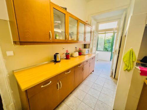 a kitchen with wooden cabinets and a yellow counter top at Fortune Guest house in Lisbon