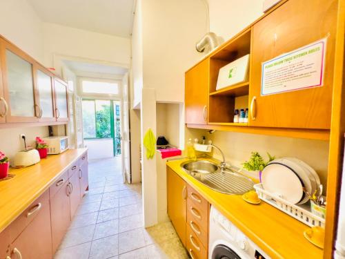 a kitchen with wooden cabinets and a sink at Fortune Guest house in Lisbon