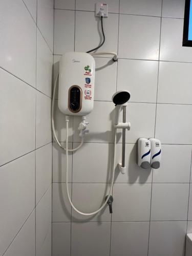 a bathroom with a shower with a phone on the wall at Imperio Professional Suite by Mama Sue in Alor Setar