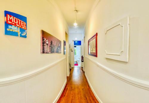a hallway with art on the walls of a house at Fortune Guest house in Lisbon