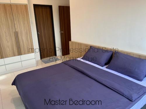 a bed with purple sheets and pillows in a room at Imperio Professional Suite by Mama Sue in Alor Setar