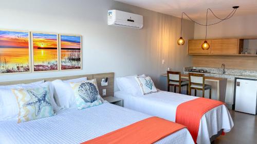 a hotel room with two beds and a kitchen at Costa Solar Lagoa in Florianópolis