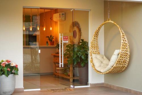 a room with a rattan swing hanging from the wall at Costa Solar Lagoa in Florianópolis