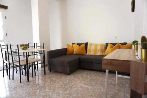 a living room with a couch and a table at Fuerteventura Beach Vacations and Blue Mango surf&fitness center at charco in Puerto del Rosario