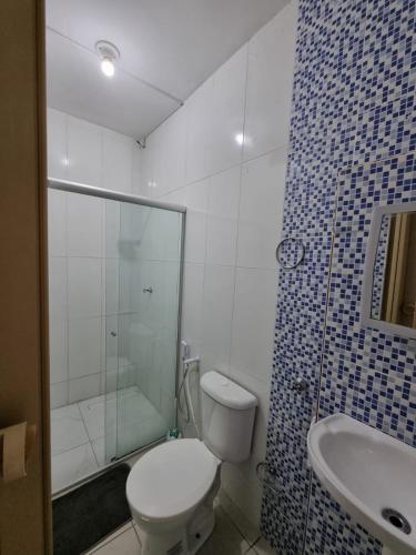 a bathroom with a toilet and a shower and a sink at Casa Aeroclube in João Pessoa