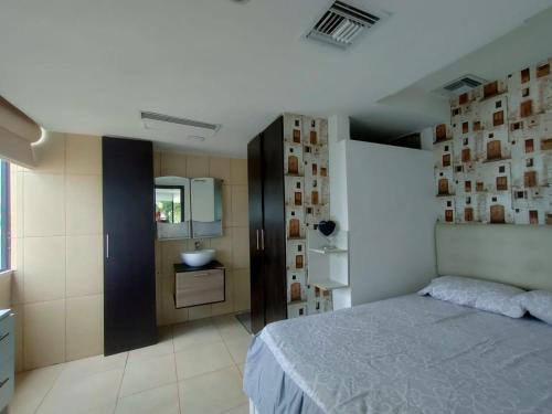 a bedroom with a bed and a sink in it at Torre Bellini in Guayaquil