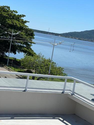 a balcony with a view of the water at Costa Solar Lagoa in Florianópolis