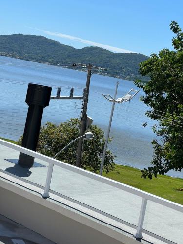a view of a body of water with a white railing at Costa Solar Lagoa in Florianópolis