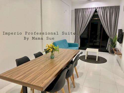 a dining room with a wooden table and chairs at Imperio Professional Suite by Mama Sue in Alor Setar