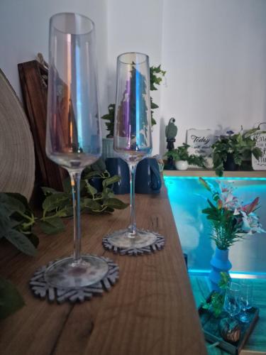 two wine glasses sitting on top of a wooden table at Kathisma Trebinje in Trebinje