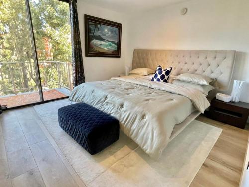 a bedroom with a large bed with a large window at Luxury Beverly Hills 24 Hour Security Home 2 Bedrooms Perfect Location in Los Angeles