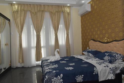 a bedroom with a bed with a white bird on it at APART VERSAI in Varna City