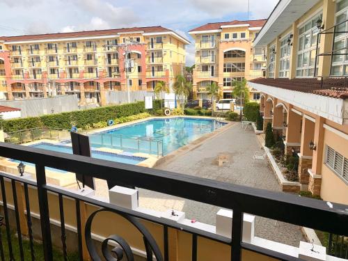 a view of a swimming pool from a balcony at Allen’s cozy condo in Davao City
