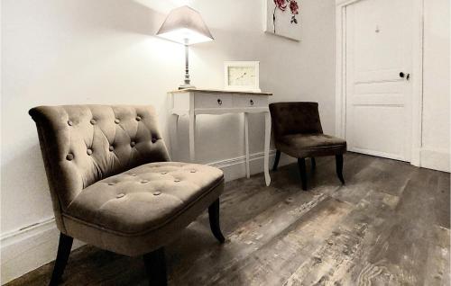 a living room with a chair and a table and a lamp at 5 Bedroom Lovely Home In Magny-En-Vexin in Magny-en-Vexin