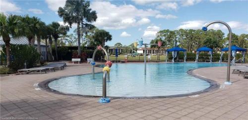 a swimming pool with a toy bird in the water at The Orchard Suite of Sebring in Sebring