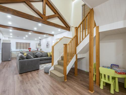 a living room with a staircase and a couch at Fir Cottage - Uk38485 in Saltash