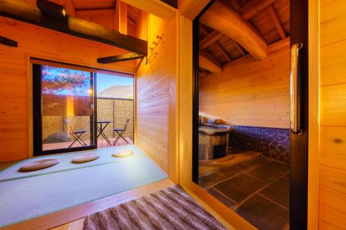 an inside view of a sauna with a window at 由布の里 旅荘 牧場の家 Ryoso Makibanoie in Yufuin
