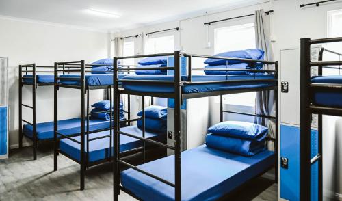 a group of bunk beds in a room at Nate's Place Backpackers Sydney in Sydney