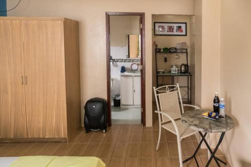 شقق جيه دبليو في انجلس: غرفة معيشة مع طاولة وكراسي ومطبخ
