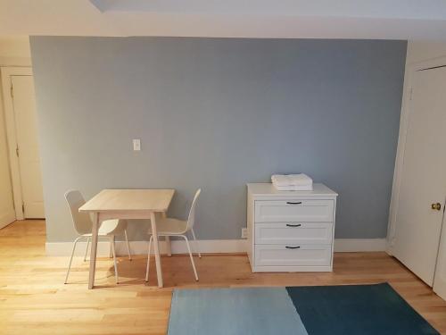 a room with a table and a table and a desk at Bright and Spacious Studio Apartment in Montréal
